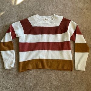 A soft cozy staple, this sweater is size small and cropped.